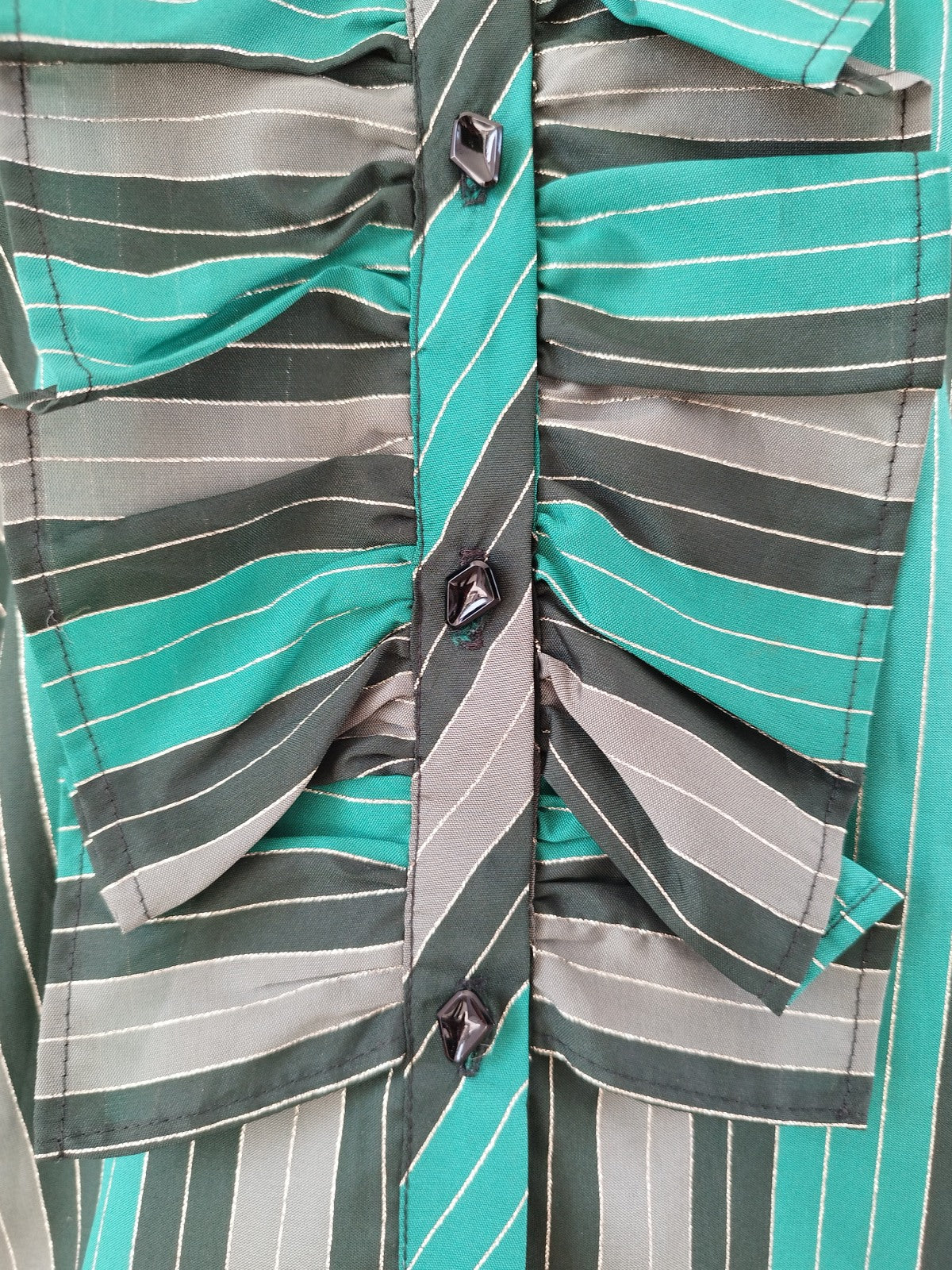 Detail of Shiny Green Striped Party Blouse with Front Ruffle