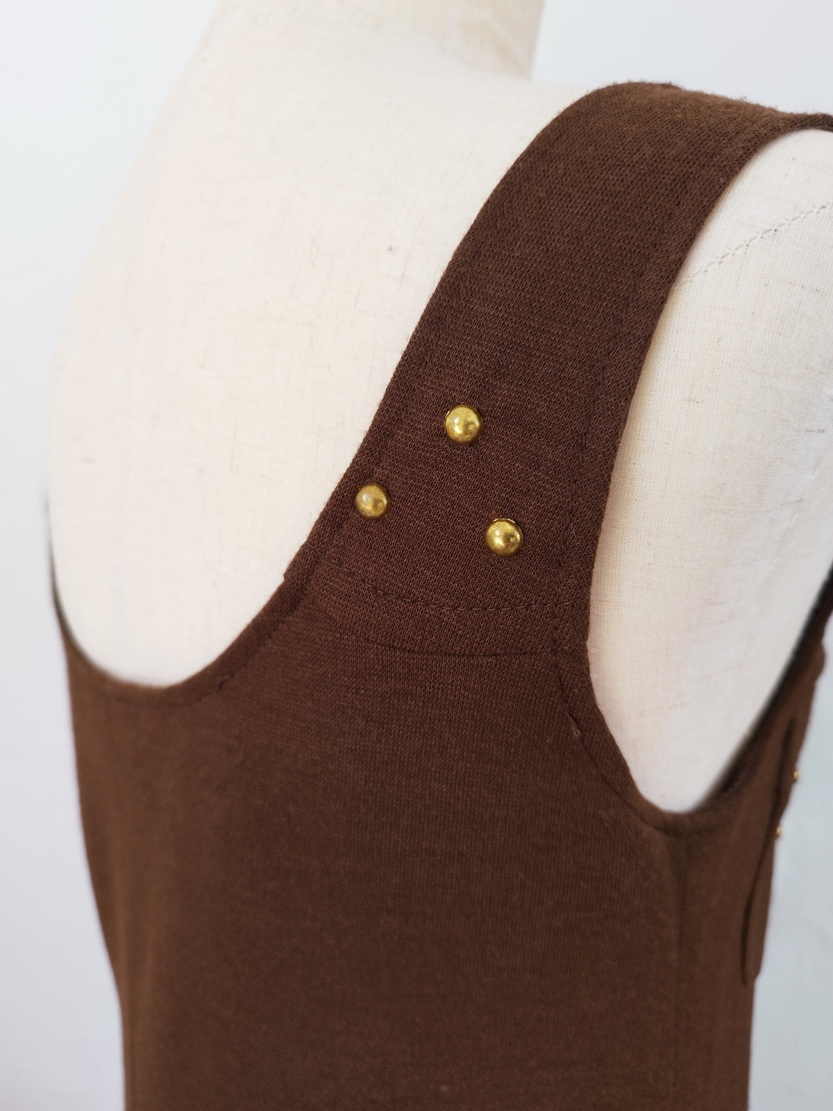 Vintage Brown Mini Dress with Straps and Brass Details Layered over a Blouse