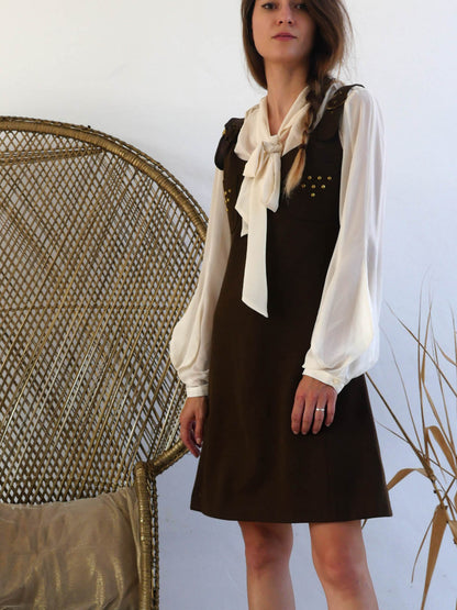 Vintage Brown Mini Dress with Straps and Brass Details Layered over a Blouse