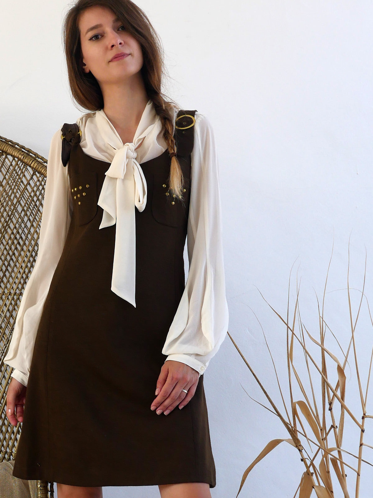 Vintage Brown Mini Dress with Straps and Brass Details Layered over a Blouse